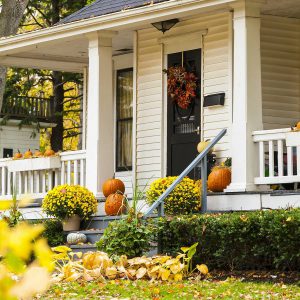 A traditional styled older home decorated in autumn decore.