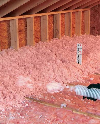 pink attic insulation being installed in a residential home