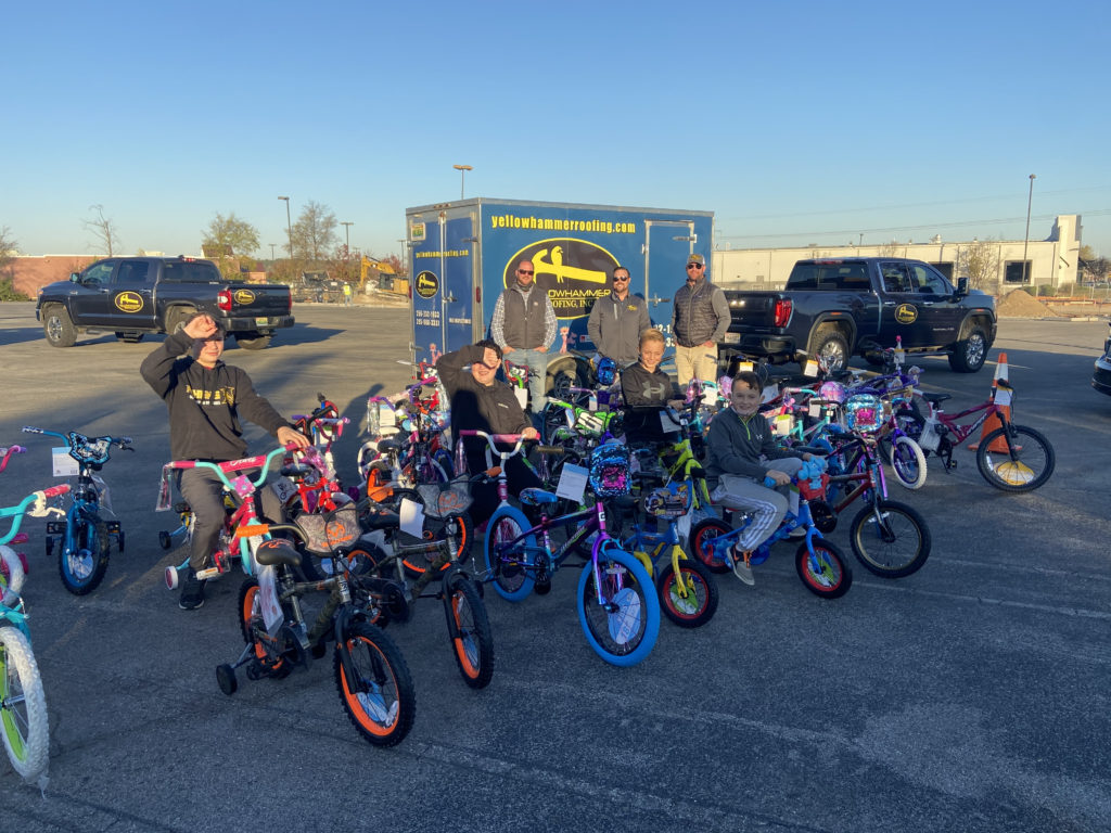 Kids sitting on some of the bikes that Yellowhammer Roofing Inc hauled to the Bike or Bust Event.