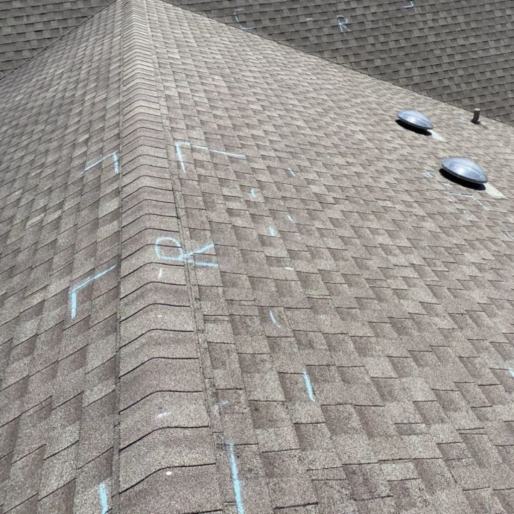 Hail damage on a shingle roof top